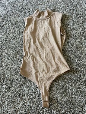 Shrinking Violet Sleeveless Mock Neck Bodysuit in Beige